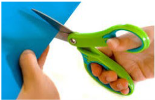 larger green handles scissors in right hand where thumb is in top handle, and all other fingers are in the bottom handle, cutting blue paper